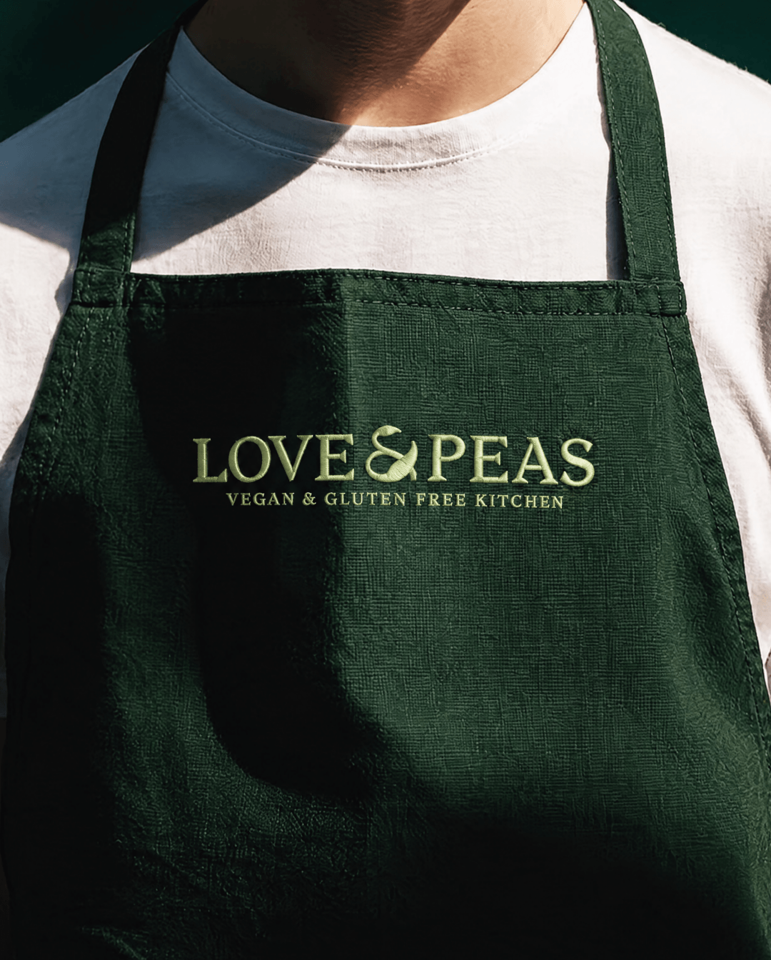 Love-Peas-brand-identity-1@3x Green apron with the Love & Peas vegan and gluten-free kitchen logo