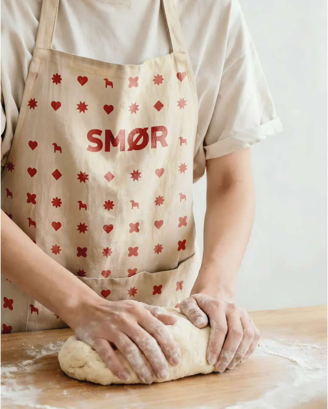 Smør Scandinavian Bakery brand refresh by Round 3, apron with folk-inspired pattern
